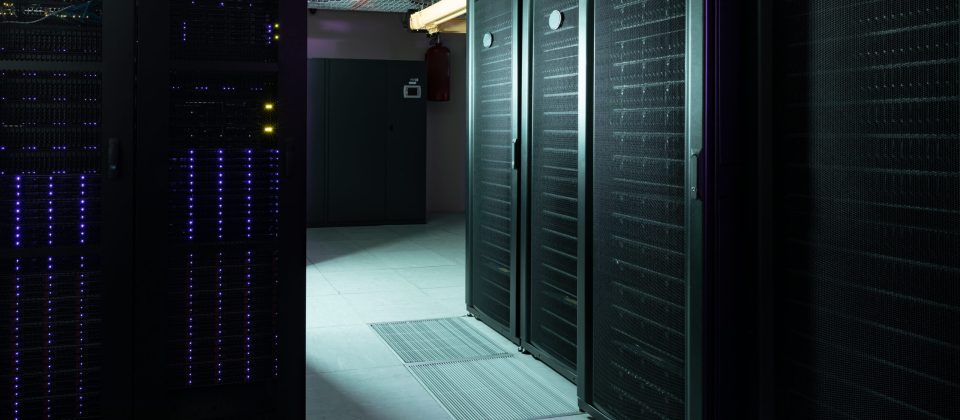 Data center with multiple rows of fully operational server racks. modern cloud computing technology concept. Datacenters ISO 14100